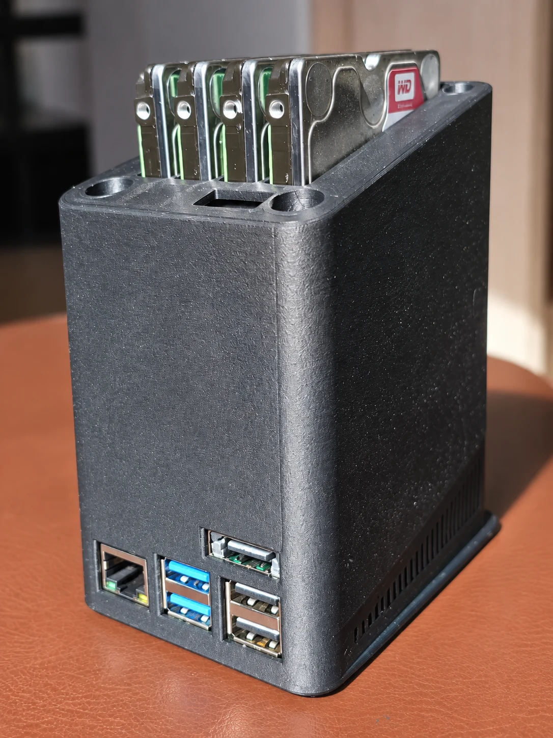 Printed lower enclosure fitted around the boards with the four drive tops still exposed
